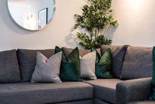 a couch with four pillows on it with a mirror at Host & Stay - Duke Street Townhouse Apartments in Liverpool