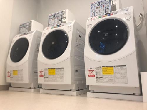 three washing machines are lined up in a room at Sapporo Washington Hotel Plaza in Sapporo