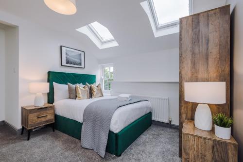 a bedroom with a large bed and skylights at Host & Stay - The Roscoe Coach House in Liverpool