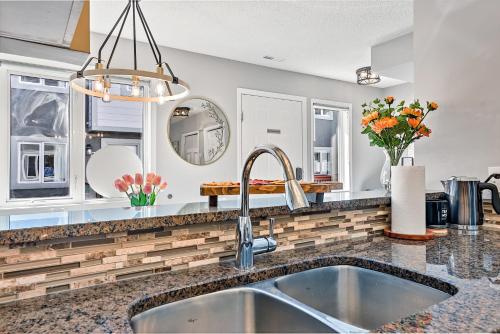 a kitchen with a sink and a mirror at The Alfar by Samsara Resort Private Entry Panorama Top View 3BR 2TH in Canmore
