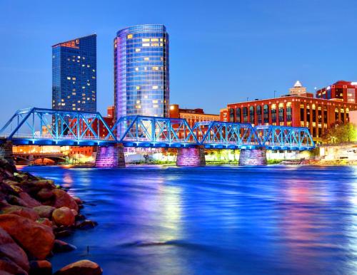 a blue bridge over a river in a city at Modern 2BR 2BA New Build Condo with Garage & Patio in Wyoming