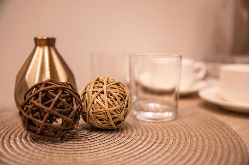 two balls sitting on a table next to a glass at Hotel Vila Hedonija in Herceg-Novi
