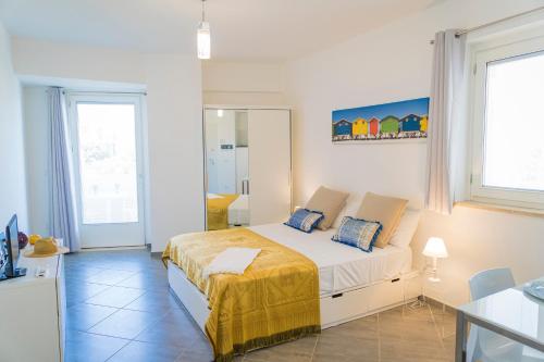a white bedroom with a bed in a room at MARIMAR - Apartments OTRANTO in Otranto