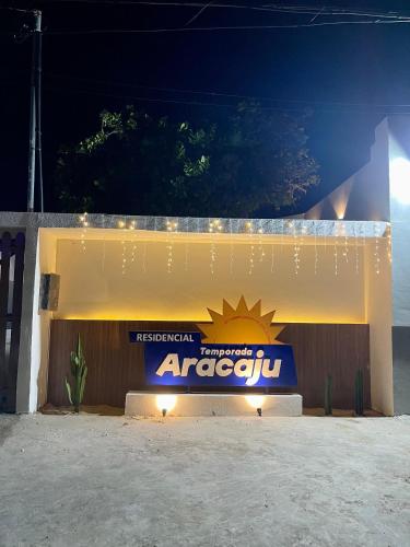 a sign on the side of a building at night at Residencial Temporada Aracaju in Aracaju
