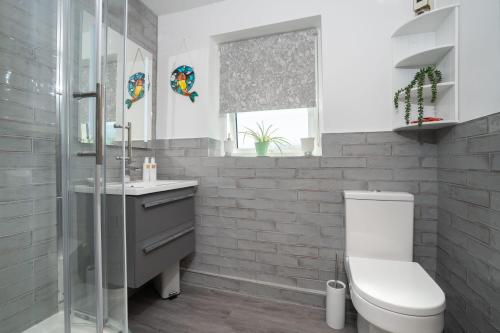 a bathroom with a toilet and a glass shower at Kentmere Haven - 2 Bedroom - Cycle Storage in Kendal