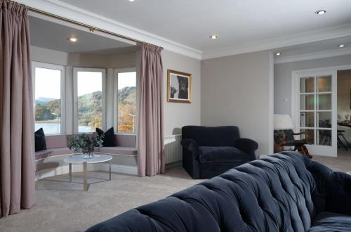 a living room with a large couch and a table at Brand New - Contemporary - 2 Bedroom - 2 Bathroom - Spacious Apartment - Lake Views in Ambleside