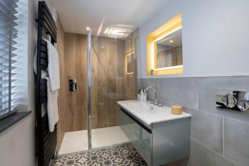 a bathroom with a sink and a shower at Spacious - Contemporary Home - Central Ambleside - Parking in Ambleside