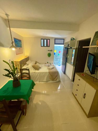 a room with a bed and a tv in it at Residencial Temporada Aracaju in Aracaju