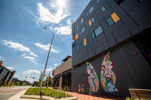 a building with a painting on the side of it at Vibrant 2BR Corner Suite and Free Parking at CityWay in Indianapolis