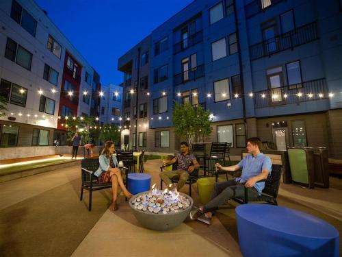 a group of people sitting in chairs in front of a building at Free parking Gym & Pool Downtown at CityWay in Indianapolis