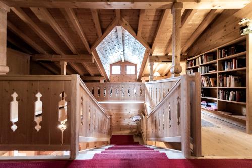 an attic room with wooden stairs and a window at Gämsle Hotel, Wirtshaus & mehr in Schoppernau