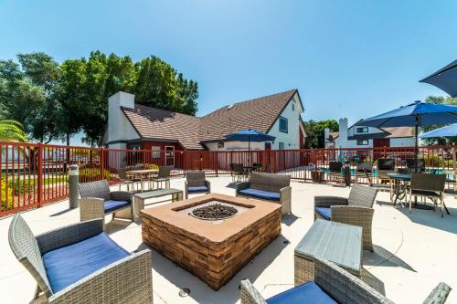 a patio with chairs and tables and a fire pit at Phoenix Studio King Deluxe in Phoenix