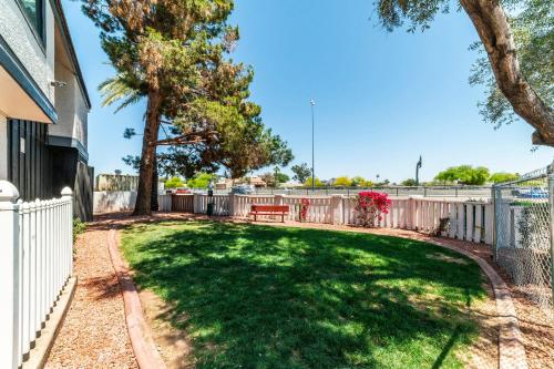 a yard with a fence and a bench at Metro PHX STUDIO QUEEN sleeps 4 HEATED POOL in Phoenix