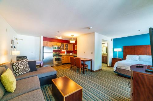 a hotel room with a couch and a bed and a kitchen at Metro PHX downstairs STUDIO sleeps 4 ADA Accessible in Phoenix