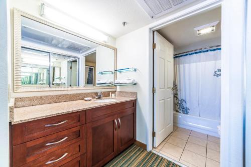 a bathroom with a sink and a mirror at Metro PHX downstairs STUDIO sleeps 4 ADA Accessible in Phoenix