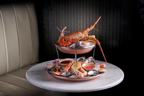 a plate of food with seafood on a table at Mayfair Hotel in Adelaide