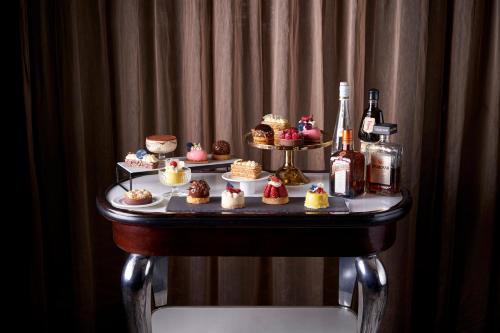 a table full of cupcakes and bottles of wine at Mayfair Hotel in Adelaide
