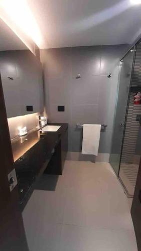 a bathroom with a shower and a sink and a mirror at Suite Exclusiva frente al mar Hotel Poseidón Manta in Manta