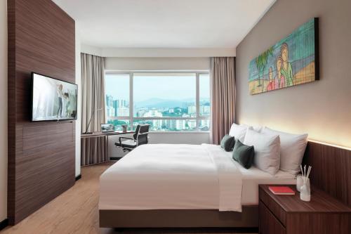 a hotel room with a large bed and a window at Oakwood Hotel & Residence Kuala Lumpur in Kuala Lumpur