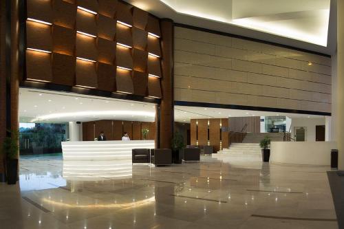 a lobby with a staircase in a building at Oakwood Hotel and Residence Kuala Lumpur in Kuala Lumpur