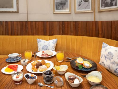 a table with plates of breakfast food on it at The Ritz-Carlton, Budapest in Budapest