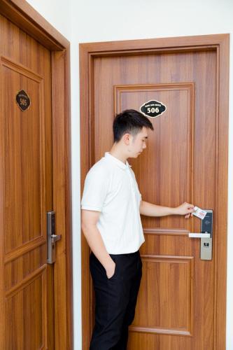 a man is standing in front of a door at Vĩnh Sơn Nội Bài in Hanoi