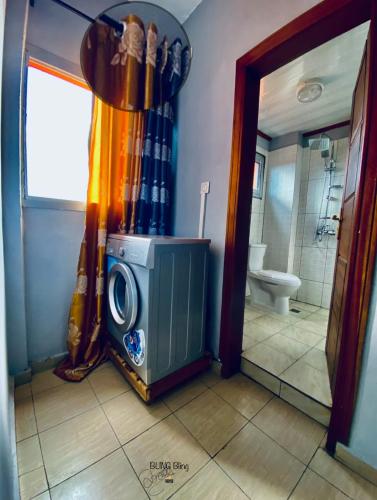 a bathroom with a television in a shower at RESIDENCE LUXALYS in Yaoundé