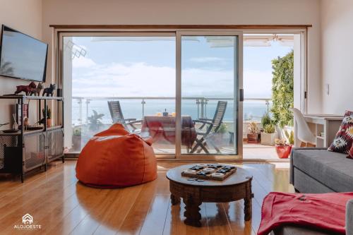 a living room with a large sliding glass door at Studio L - Ericeira in Ericeira