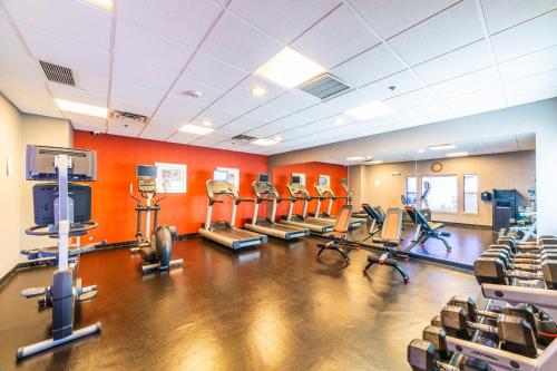 a gym with a bunch of cardio equipment in a room at Metro Extended Stays Phoenix - 2BR Upstairs in Phoenix