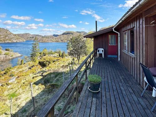 a house with a deck with a view of a lake at 5 person holiday home in FARSUND in Helle