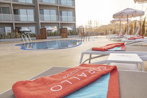 a towel on a table in front of a pool at Corallo By Josun in Yangyang