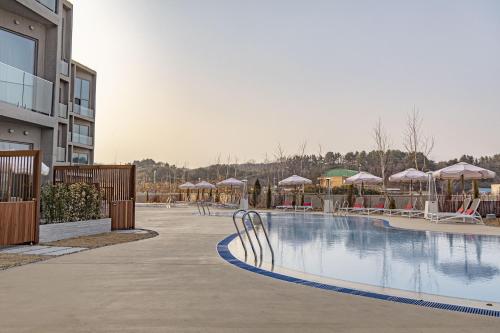 una piscina con sedie e ombrelloni in un resort di Corallo By Josun a Yangyang