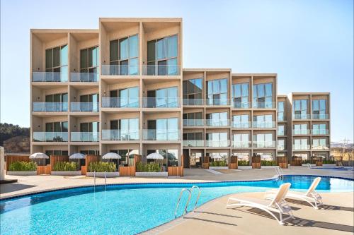 襄陽郡的住宿－Corallo By Josun，一座带游泳池的公寓大楼的图片