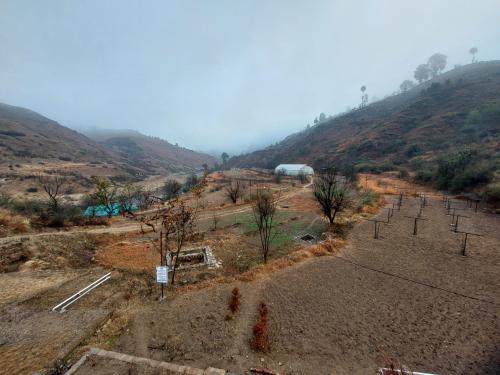 an aerial view of a farm on a hill at Himkosi Farm by the River in Almora