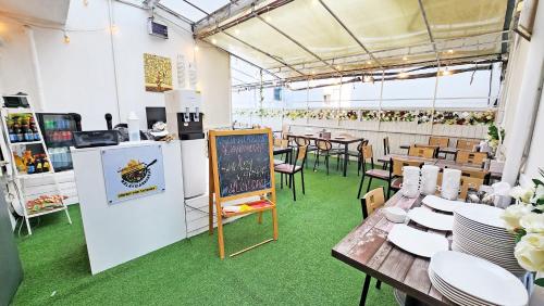 a restaurant with tables and chairs and a chalkboard at Amiga Inn Seoul Hotel in Seoul