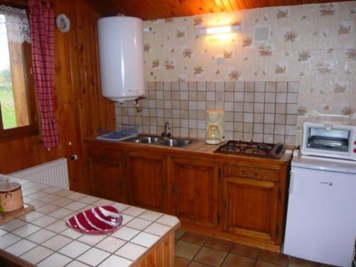 a kitchen with a sink and a counter top at Gîte nature, 15 km de Gérardmer, randonnée, ski, jardin, terrasse, BBQ, équipements bébé inclus - FR-1-589-64 in Champdray