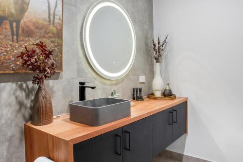 a bathroom with a sink and a mirror at 16 Scenic by Regional Escapes in Geelong