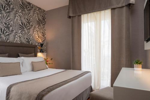 a hotel room with a bed and a window at Hotel Maestrale in Riccione