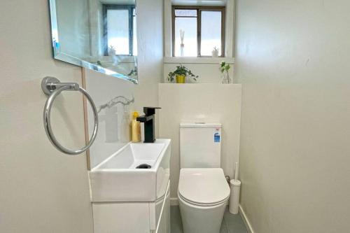 a small bathroom with a toilet and a sink at Maroondah 3BR Brick Entire Home Free Wi-Fi Parking in Ringwood
