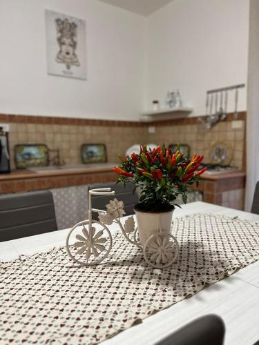 a table with a vase with a plant on it at Marea affittacamere in Porto Empedocle