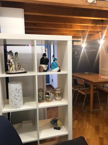a shelf in a room with a table at Mia Home in Bologna