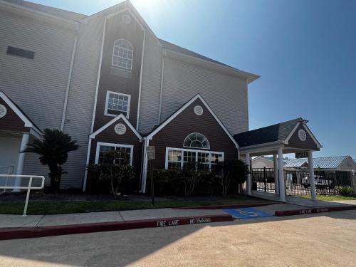 a church with a large building with a sign in front at Microtel Inn & Suites by Wyndham Houston/Webster/Nasa/Clearlake in Nassau Bay