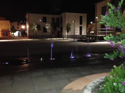 a fountain in front of a building at night at Hotel La Barcarola in Marina di Campo