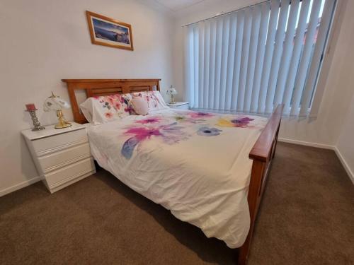 a bedroom with a large bed and a window at Glass House Mountains Retreat in Beerwah