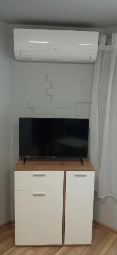 a living room with a tv on top of a cabinet at Varna Studio 2 in Varna City