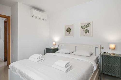 two white beds in a white room with two lamps at Smart rooftop in Fuengirola Ref 212 in Fuengirola