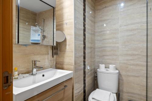 a bathroom with a white toilet and a sink at Smart rooftop in Fuengirola Ref 212 in Fuengirola