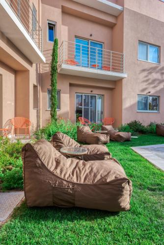 a row of bean bags on the grass in front of a building at Saronis Suites in Saronida