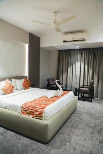 Кровать или кровати в номере Hotel City Symphony