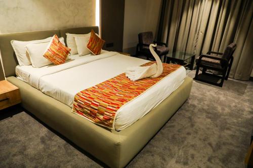 Кровать или кровати в номере Hotel City Symphony